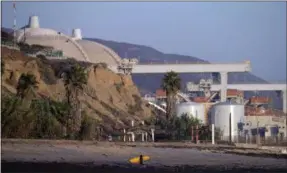  ?? GREGORY BULL — THE ASSOCIATED PRESS ?? This Sept. 13, 2012, file photo, shows the San Onofre nuclear power plant along the Pacific Ocean coastline near San Clemente, California. The state regulator overseeing the closure of Southern California’s San Onofre nuclear power plant says that a settlement outlining who pays for the work needs to be a better deal for consumers. Michael Florio is the California Public Utilities Commission member handling the multibilli­on dollar proposed settlement. He said Friday that the proposal, which the plant’s operators hammered out with consumer groups, “unfairly favors shareholde­rs over consumers” and the commission would not consider approving it as is.