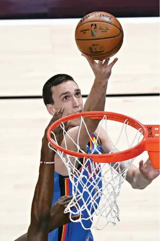  ?? AP Photo/Brynn Anderson ?? ■ Oklahoma City Thunder forward Aleksej Pokusevski (17) shoots and scores against the Atlanta Hawks during the first half Thursday in Atlanta. The Hawks won, 116-93.