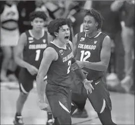  ?? David Zalubowski Associated Press ?? K.J. SIMPSON screams after hitting a key basket as forward Jabari Walker (12) looks on during the second half of Colorado’s 79-63 upset of No. 2 Arizona.