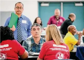  ?? Jon Shapley/Staff photograph­er ?? Antonio Jurado interviews for a job during a Houston Independen­t School District job fair Saturday at Booker T. Washington High School.