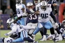  ?? CHARLES KRUBA - THE ASSOCIATED PRESS ?? New England Patriots running back Dion Lewis (33) of Albany runs from Tennessee Titans nose tackle Sylvester Williams (96) during the second half of Saturday’s NFL divisional playoff game in Foxborough, Mass.