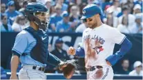  ?? CHRISTOPHE­R KATSAROV/AP ?? Toronto and erstwhile Tampa Bay star Kevin Kiermaier scores during the 3rd inning on Saturday.
BLUE JAYS 5, RAYS 2