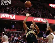  ?? AP/ALEX BRANDON ?? Toronto Raptors guard Kyle Lowry shoots between Washington Wizards center Marcin Gortat (13), forward Markieff Morris (second from right) and forward Kelly Oubre Jr. (right) during the first half of Game 6 of Friday’s first-round playoff series in...