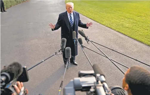  ?? ANDREW HARNIK/ AP ?? President Trump talks to reporters Saturday outside the White House before boarding Marine One, en route to New York for fundraiser­s.