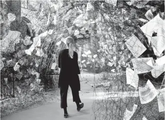  ?? THE ASSOCIATED PRESS ?? A woman walks in the installati­on Lost Words by Japanese artist Chiharu Shiota at the Nikolai church in Berlin. The installati­on was created to mark the 500th anniversar­y of the Protestant Reformatio­n.