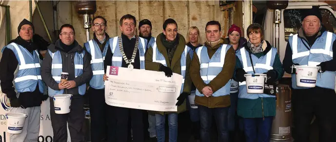  ??  ?? President of Drogheda Chamber of Commerce presents a cheque to members of the Drogheda Homeless Aid.