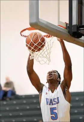  ?? PATRICK HOPKINS — THE NEWS-HERALD ?? VASJ’s Latrace Jackson throws down a dunk during the Vikings’ victory over Glenville on March 8 at Lakeside.