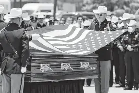  ?? Melissa Phillip / Staff photograph­er ?? Harris County Sheriff ’s Honor Guard members fold the American flag Thursday during Deputy Omar Diaz’s funeral at Champions Forest Baptist Church.