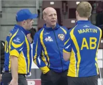  ?? ANDREW VAUGHAN, THE CANADIAN PRESS ?? Kevin Martin, coach of the Alberta team, talks with Darren Moulding, left, and his son Karrick Martin in action against New Brunswick at the Tim Hortons Brier in St. John’s on Monday.