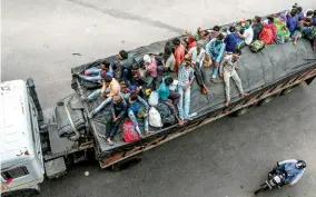  ??  ?? SUCH A LONG JOURNEY Migrant workers travelling back to their villages, in Lucknow
