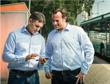 ??  ?? Nir Erez (left) and Roy Bick founded Moovit to help bus and train commuters, encourage residents to ditch their cars and make cities more livable.