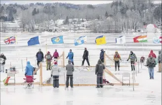  ?? Photo by Trudi Shaffer Hargis ?? Racers compete at the Memphremag­og Winter Swim Festival in Newport, Vt. Before signing up, competitor­s must show they’ve been swimming in water 41 degrees or colder.