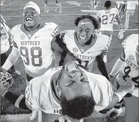  ?? AP/CHARLIE RIEDEL ?? Kentucky players celebrate Saturday after defeating Missouri 15-14 with a touchdown on the game’s final play. If the No. 9 Wildcats defeat No. 6 Georgia on Saturday, they will win the SEC East title.