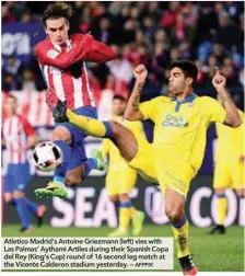  ?? AFPPIX ?? Atletico Madrid’s Antoine Griezmann (left) vies with Las Palmas’ Aythami Artiles during their Spanish Copa del Rey (King’s Cup) round of 16 second leg match at the Vicente Calderon stadium yesterday. –