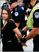  ??  ?? UNDER ARREST: A woman being detained in Washington yesterday