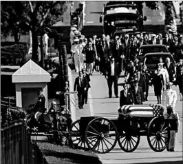  ?? SUSAN WALSH/AP ?? Family members follow a horse-drawn caisson that carries the casket of Sen. John McCain, R-Ariz., as it proceeds to the United States Naval Academy cemetery.