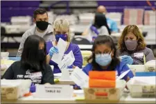  ?? SETH WENIG — THE ASSOCIATED PRESS FILE ?? In this Oct. 24, 2020 file photo, ballot board workers process mail-in ballots at Bergen Community College in Paramus, N.J.