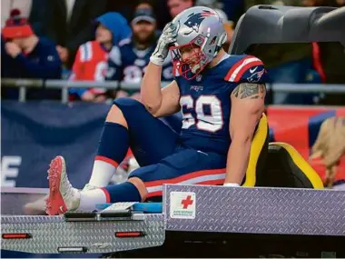  ?? MATTHEW J. LEE/GLOBE STAFF ?? The Patriots’ offensive line was dealt a big blow when left guard Cole Strange was carted off — to his chagrin — in the second quarter with a left knee injury.