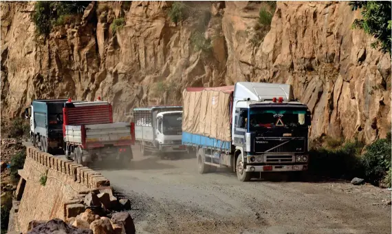  ?? AFP ?? Vehicles are pictured on a damaged road, the only travel route between Yemen’s cities of Taiz and Aden. Yemen has been left in ruins by six years of war, where over 24 million people are in need of aid and protection.