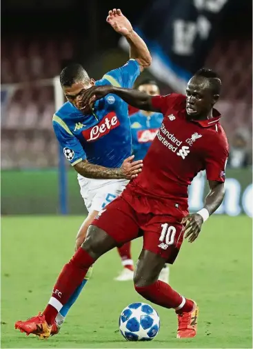  ?? — AP ?? Getting rough: Napoli midfielder Allan (left) vying for the ball with Liverpool midfielder Sadio Mane during the Champions League Group C match at the San Paolo on Wednesday.