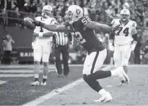  ??  ?? Raiders defensive end Khalil Mack scores a touchdown after intercepti­ng a pass by Carolina quarterbac­k Cam Newton last Sunday. Tony Avelar, The Associated Press