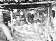  ??  ?? A home visit to a Penan patient, who lives with his family in a ramshackle hut.