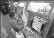  ?? / AP-Joe Skipper, File ?? In this 1987 file photo, Carlos Tunnerman, 10, plays the “Contra” video game at an arcade in Miami, Fla. Decades of study have failed to validate the most prevalent fear, that violent games encourage violent behavior. But from the moment the games emerged as a cultural force in the early 1980s, parents fretted about the way kids could lose themselves in games as simple and repetitive as “Pac-Man,” “Asteroids” and “Space Invaders.”