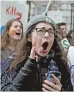  ??  ?? HEAR THIS: Dozens of students marched from St. Paul’s Cathedral on Tremont Street to the State House to demand stricter gun-control measures.