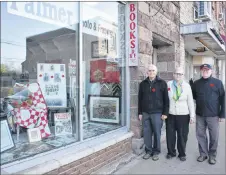  ?? ADAM MACINNIS/THE NEWS ?? Clyde Macdonald, right, along with Art and Hazel Palmer, owners of Palmer Photo and Framing, have compiled artifacts commemorat­ing Canada’s involvemen­t in the First and Second World War in the window of the Palmers’ New Glasgow business. Included are some medals from a relative of Macdonald’s who fought in the war as well as medals that Hazel Palmer’s father earned.