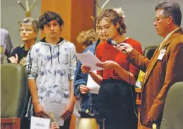  ??  ?? High school student Sophia Lussiez, 17, of Santa Fe testifies in support of proposals for new gun safety regulation­s in the state. The Legislatur­e is considerin­g a bill that would temporaril­y restrict firearms access for people considered to be at risk to themselves or others. Fourteen states now have such laws.