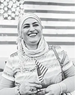  ?? DANIELLE LUNA ?? Nada al-Rubaye, an Iraqi refugee, at her 2019 naturaliza­tion ceremony in Phoenix. The artist left Baghdad after one of her sons and several other relatives were killed.