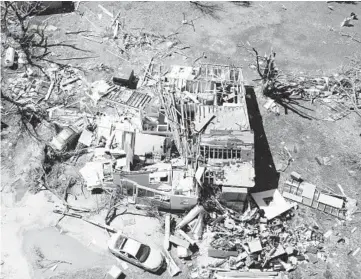  ?? JAIME GREEN/THE WICHITA EAGLE ?? Tornado’s wrath: A home destroyed by a tornado is seen Saturday in Andover, Kansas. Officials said the twister hit southeast Wichita and Andover on Friday evening. They also said several people were injured and thousands were left without power. Andover Fire Chief Chad Russell said 50 to 100 buildings were damaged in Sedgwick County.