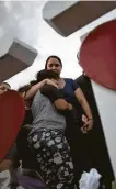  ?? Mark Lambie / Associated Press ?? A mother holds her daughter at a vigil for victims of the mass shooting that claimed 22 lives in El Paso.