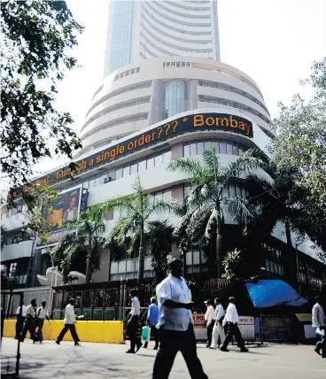  ?? SAJJAD HUSSAIN / AFP / GETTY IMAGES FILES ?? PwC projects that emerging markets — such as India’s where the Mumbai Stock Exchange resides — to overtake developed markets by 2050.