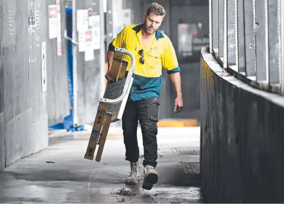  ?? ?? A tradesman packs up his equipment at a Probuild site in Brisbane. Probuild was one of Australia’s biggest constructi­on companies. Picture: Dan Peled