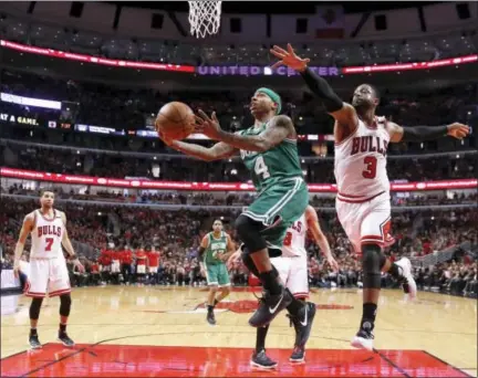  ?? CHARLES REX ARBOGAST — THE ASSOCIATED PRESS ?? The Celtics’ Isaiah Thomas, left, drives past the Bulls’ Dwyane Wade in the second half Friday in Chicago.