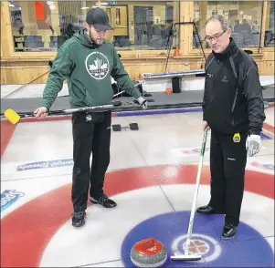  ?? CHARLES REID/THE GUARDIAN ?? Second Chris Gallant, left, and lead Sean Ledgerwood of the Eddie MacKenzie rink discuss strategy at a recent practice in Cornwall. Last year’s P.E.I. Tankard champs start their defence of their provincial title today at the Cornwall Curling Club.