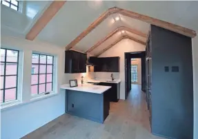  ??  ?? French doors, hardwood floors, stainless-steel appliances and granite counter tops bring a luxurious finish. Some models have exposed wooden ceiling beams, porches and Poplar bark siding.