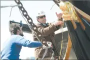  ?? SEAN D. ELLIOT/THE DAY ?? Lead Shipwright Rob Whalen, right, gives some suggestion­s to shipwright Matt Barnes as he works on various parts of the bow on March 25.