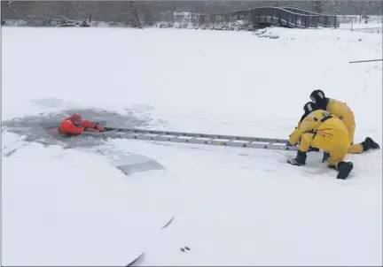  ?? SUBMITTED BY JERRY CRADDOCK ?? Mentor Fire Department performs an ice rescue drill at Garfield Park