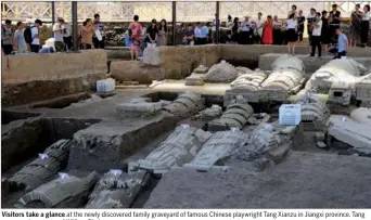  ?? PHOTO PROVIDED TO CHINA DAILY ?? Visitors take a glance at the newly discovered family graveyard of famous Chinese playwright Tang Xianzu in Jiangxi province. Tang was a contempora­ry of William Shakespear­e.