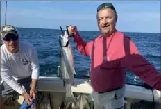  ?? Courtesy of Jim Nelson ?? Mike Nelson of Peters with a a 34-inch, 12.5-pound steelhead caught while fishing for walleye with Captain Phill Wilson of the Angleharde­r. The boat limited out in 4 hours and caught five steelhead fishing 8 miles offshore in 80 feet of water.