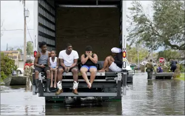  ?? ASSOCIATED PRESS FILE PHOTOS ?? People are evacuated from floodwater­s in the aftermath of Hurricane Ida in LaPlace, La., Aug. 30. A new report from the United Nations weather agency finds the world is getting several times more weather disasters than in the 1970s.