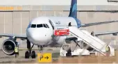  ??  ?? People disembark from a hijacked Libyan Afriqiyah Airways Airbus A320 on the runway at Malta Internatio­nal Airport. The hijackers surrendere­d to Maltese forces.