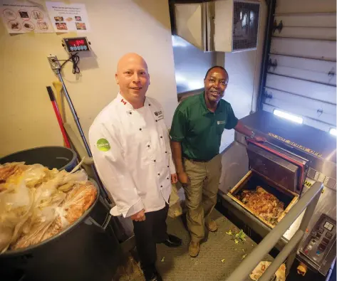  ?? LIAM RICHARDS ?? U of S grounds manager Gift Marufu, right, and culinary services director and executive chef Jame Mcfarland stand by the dehydrator at Marquis Hall on campus. Dehydrated food waste is used for composting elsewhere on campus.