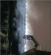  ?? PICTURE: REUTERS ?? Smoke rises after water was sprayed on the tower block damaged by a fire, in Kensington, West London.