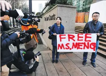  ?? JONATHAN HAYWARD/THE CANADIAN PRESS ?? Supporters of Huawei chief financial officer Meng Wanzhou protest outside a Vancouver courthouse prior to Meng’s bail hearing Monday. Trade Minister Jim Carr tried to downplay the growing rift between Canada and China following the arrest of the Chinese executive over fraud charges.