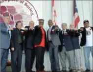  ?? JOHN BREWER - ONEIDA DAILY DISPATCH ?? From left to right, Internatio­nal Boxing Hall of Fame Class of 2019induct­ees: Teddy Atlas, Don Elbaum, Lee Samuels, Julian Jackson, Donald Curry, Tony DeMarco, Guy Jutras and Buddy McGirt display their IBHOF rings during the induction ceremony Sunday, June 9, 2019, in Canastota, N.Y.