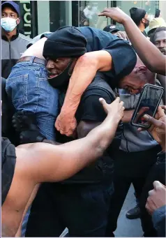  ?? Picture: GETTY ?? HEROIC: Patrick Hutchinson carried a counter-protester to safety