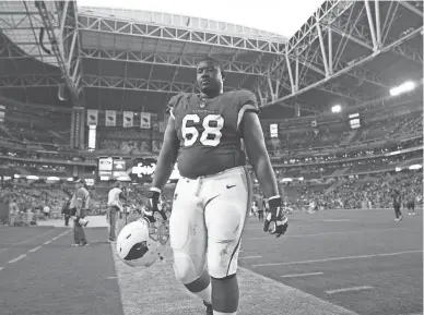  ?? JOE RONDONE/THE REPUBLIC ?? Cardinals offensive lineman Kelvin Beachum walks off the field after Arizona’s 25-24 loss to the Los Angeles Chargers on Sunday at State Farm Stadium in Glendale.